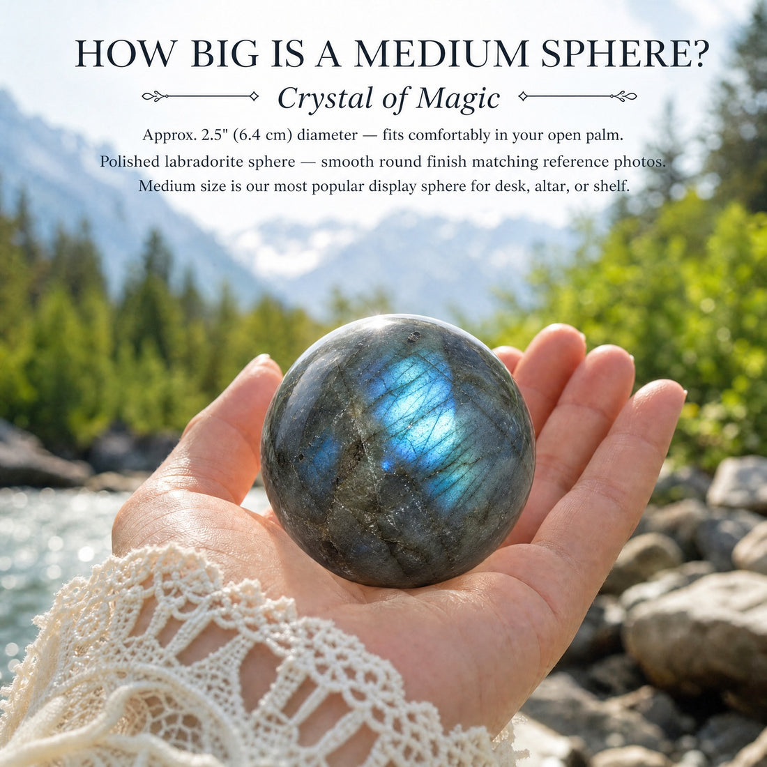 A polished labradorite sphere resting in an open hand beside a mountain river, flashing bright blue