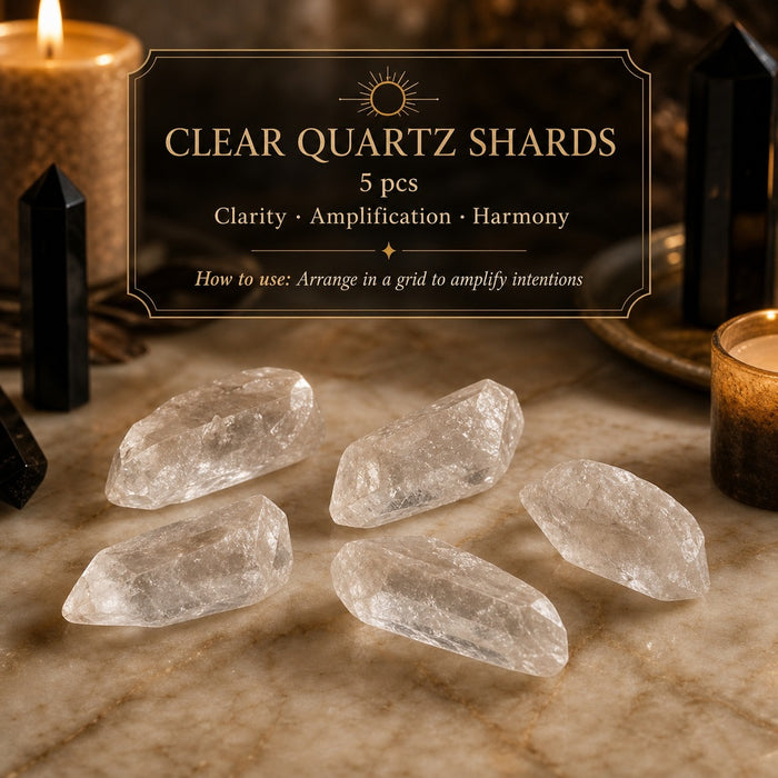 Five rough clear quartz shards on marble