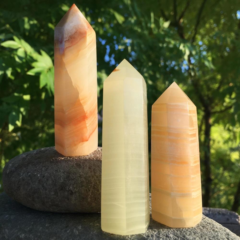 Three Afghanistan jade points side by side, from pale lemon to warm peach and orange