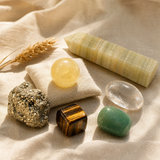 Money Magnet Mindset crystal kit on cream linen with the Mini Sphere citrine as centerpiece, plus pyrite cluster, tiger's eye sphere, green aventurine sphere, clear quartz wand, and Afghan jade point.