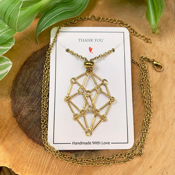 The gold-tone chain-basket necklace on its card with the chain laid out